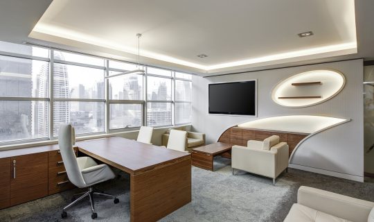 主题大赛评审委员会会议室内，评委们围坐圆桌讨论入围作品，桌上摆放着多份参赛方案打印稿
